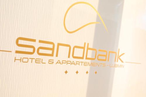 a sign for a hotel andaplements team at Sandbank Hotel & Appartements Lubmin in Lubmin