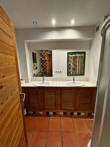 a bathroom with two sinks and a large mirror at Casa Amparo in Jávea
