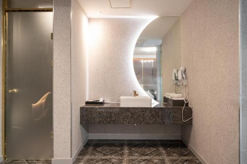 a bathroom with a sink and a mirror at Hotel Voll in Seoul
