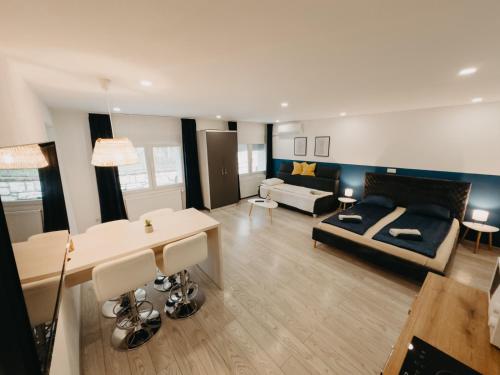 a living room with a couch and a table at Marcos Apartments Victoriei - self check-in in Reşiţa