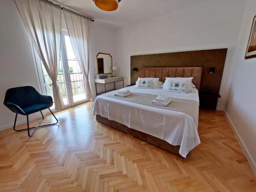 a bedroom with a bed and a chair and a television at Holiday house with pool and whirlpool Sara in Betina
