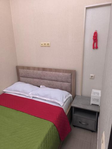 a bedroom with a bed with a red teddy bear on the wall at Seaside Apartment in K'obulet'i