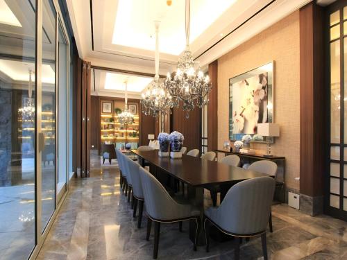 a dining room with a black table and chairs at Luxurious 1 Icon 3BR Apartment in Tunjungan Plaza 6 Surabaya City Centre by Le Ciel Hospitality in Surabaya