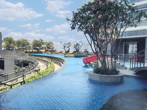 a water park with a pool and a water slide at Luxurious 1 Icon 3BR Apartment in Tunjungan Plaza 6 Surabaya City Centre by Le Ciel Hospitality in Surabaya