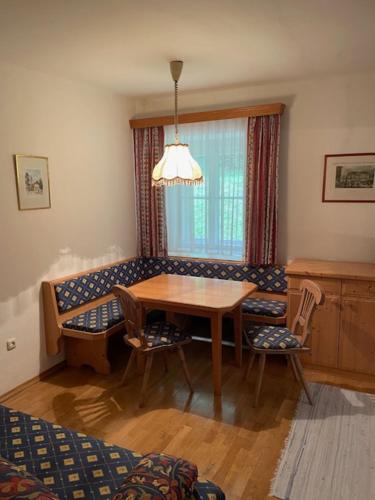 a dining room with a table and chairs and a couch at Ferienwohnungen Taverne in Langau