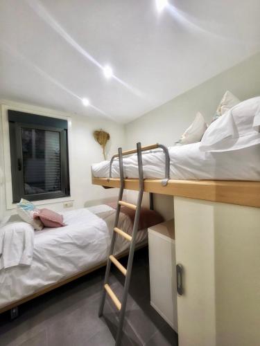 a room with two bunk beds and a ladder at Casa de Arena 1 in Nigrán