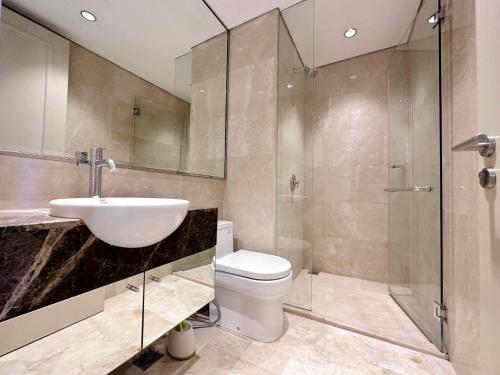 a bathroom with a sink and a toilet and a shower at Luxurious 1 Icon 3BR Apartment in Tunjungan Plaza 6 Surabaya City Centre by Le Ciel Hospitality in Surabaya