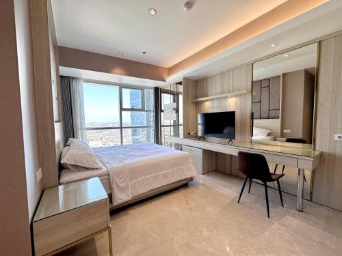 a bedroom with a bed and a desk with a television at Luxurious 1 Icon 3BR Apartment in Tunjungan Plaza 6 Surabaya City Centre by Le Ciel Hospitality in Surabaya