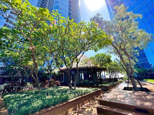 a park with trees and a gazebo in a city at Luxurious 1 Icon 3BR Apartment in Tunjungan Plaza 6 Surabaya City Centre by Le Ciel Hospitality in Surabaya