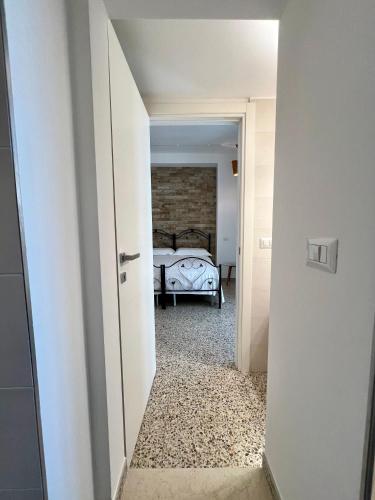 a hallway leading to a bedroom with a bed at Casa La Salsa in Pisticci