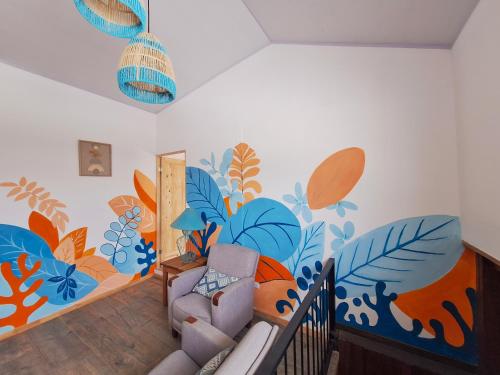 a living room with a mural on the wall at Jungla Urbana, BnB in Pavas