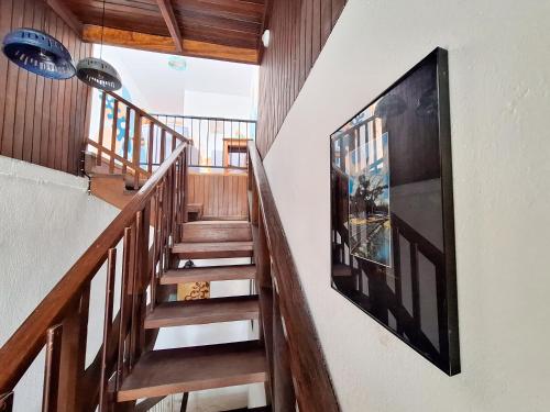 a staircase in a house with a picture on the wall at Jungla Urbana, BnB in Pavas