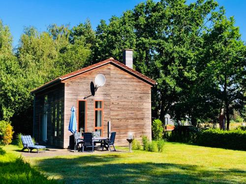 een kleine hut met een tafel en stoelen in een tuin bij OstseeFreiheit in Bodstedt