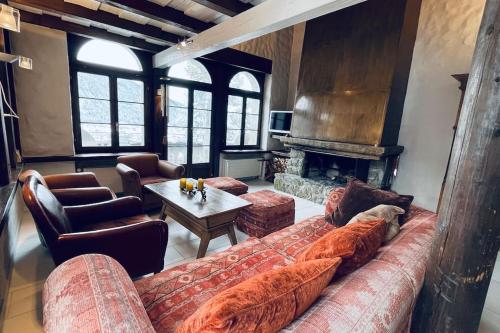 a living room with a couch and a fireplace at WEF 2026 Exclusive 160mq Castle Apartment in Davos -now available again in Davos