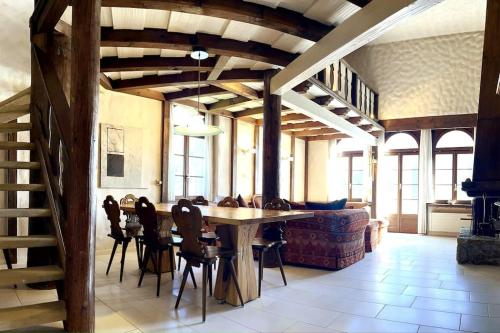 a dining room with a table and chairs and a couch at WEF 2026 Exclusive 160mq Castle Apartment in Davos -now available again in Davos