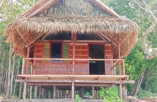 a small hut with a thatched roof at Risen Raja Ampat in Pulau Birie