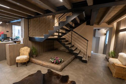 a living room with a staircase with a bench under it at Le Suites de San Campel RTA in Ponte di Legno