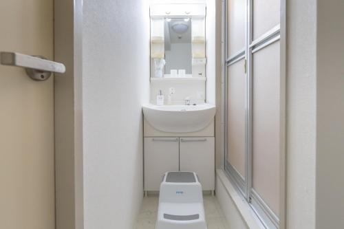 a bathroom with a toilet and a sink at Dotonbori East Residence Haru - Self Check-In Only in Osaka