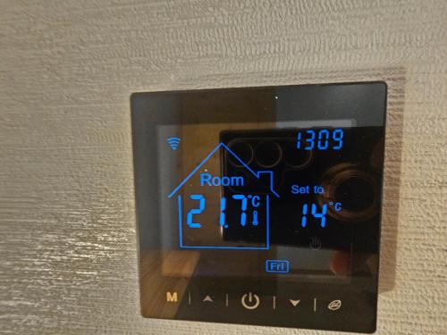 an alarm clock with a room number on it at Nad Potokiem z Alpakami in Stronie Śląskie