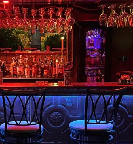 a bar with two chairs in front of a bar at RoofTop Boutique Hotel Adults Only in Serekunda