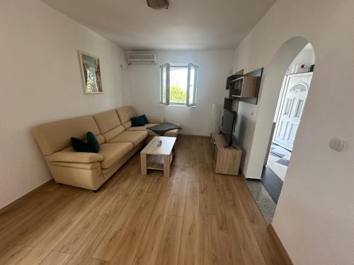 a living room with a couch and a table at Villa Vukic in Krimovice