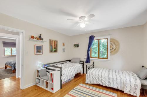 a bedroom with two beds and a ceiling fan at Robin's Rest home in Chapel Hill
