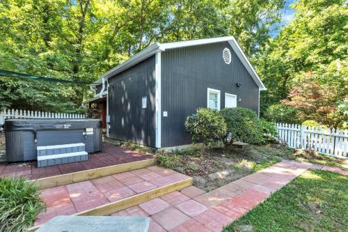 a black tiny house with a brick patio at Robin's Rest home in Chapel Hill
