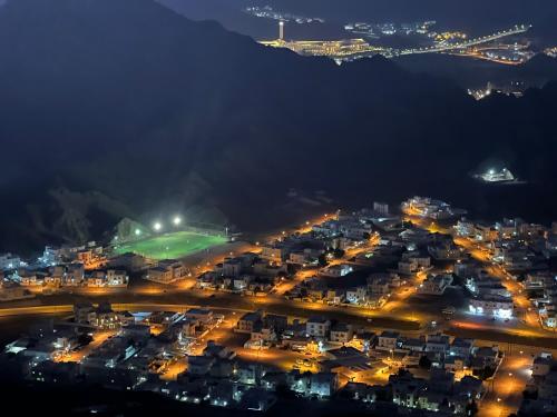 an aerial view of a city at night at Qantab Hut in Muscat