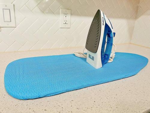 a iron sitting on top of a blue rug at OKC Casita - Private Hot Tub, Fenced Yard, Mins to Top Spots, Pet friendly in Oklahoma City