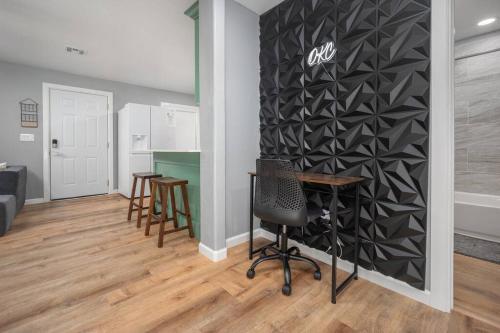 a room with a table and chairs and a wall at OKC Casita - Private Hot Tub, Fenced Yard, Mins to Top Spots, Pet friendly in Oklahoma City