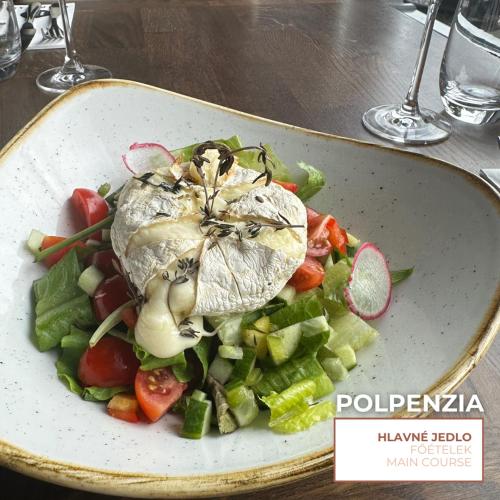 a plate of food with vegetables on a table at HOTEL EUROPA in Komárno