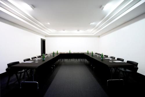a room with a long table with chairs in it at Hotel Clarin in Oviedo