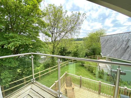 a balcony with a view of a yard at Trewhiddle Retreat V11 by Together Travel - Luxury 4-Bedroom Villa in St Austell