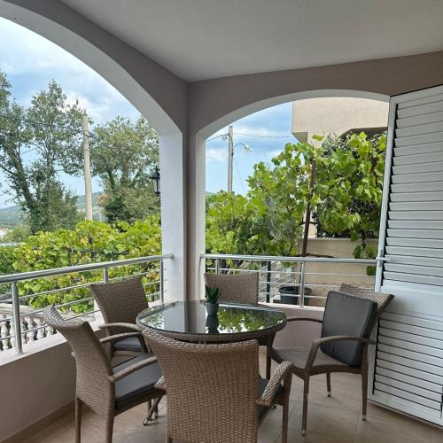 a patio with a table and chairs on a balcony at Villa Vukic in Krimovice
