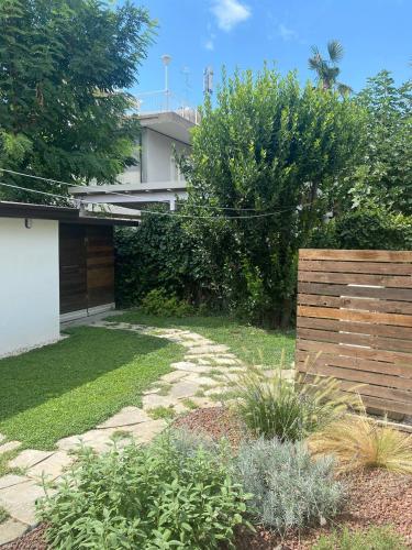 a garden with a stone path in front of a house at MAISON ANZIO E ROSA in Ravenna