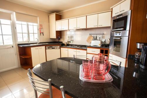 a kitchen with a table with glasses on it at Villa Margarida in Ponta do Sol