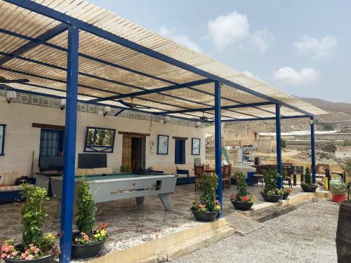 a patio with a ping pong table and potted plants at Bonitas vistas al mar in Almería