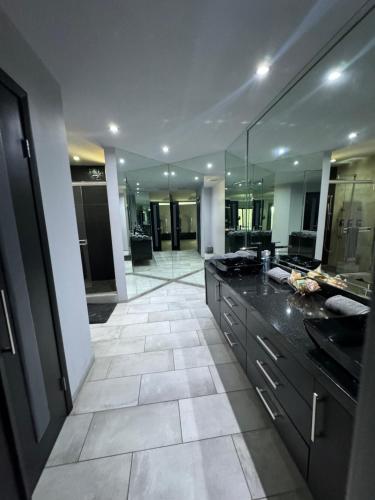 a bathroom with two sinks and a large mirror at Riviera Beach Condo in Rosarito