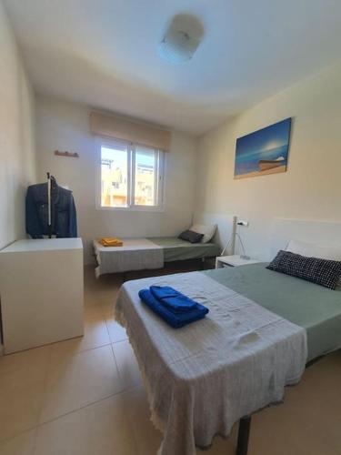 a room with two beds and a couch in it at Paraíso Vera Playa in Playas de Vera