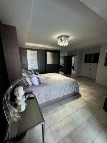 a bedroom with a bed and a glass table at Riviera Beach Condo in Rosarito