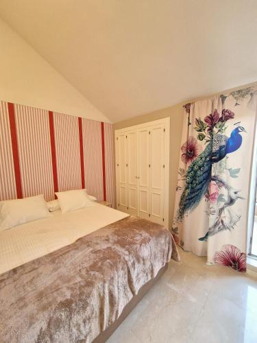 a bedroom with a bed and a window at Soto Blues Sotogrande - Puerto Deportivo in Sotogrande