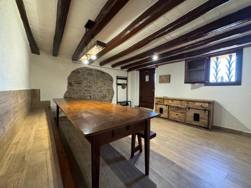 a room with a wooden table in a building at Casa Rural CAL PAGÉS Montseny in Montseny