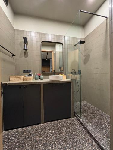 a bathroom with a sink and a mirror at Krtsanisi Grande apartment in Tbilisi City