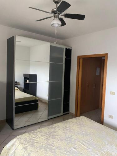 a bedroom with a bed and a large mirror at Appartamento al mare - Marotta in Marotta