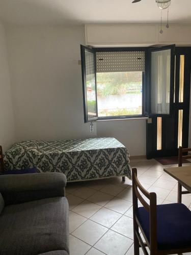 a living room with a bed and a window at Appartamento al mare - Marotta in Marotta