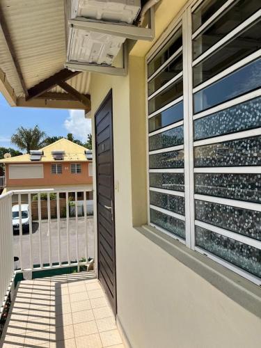 a view from a balcony of a house at Appartement Cayenne Chic Design Élégant en Bois Tropical in Cayenne