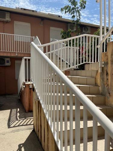 a set of stairs in front of a house at Appartement Cayenne Chic Design Élégant en Bois Tropical in Cayenne
