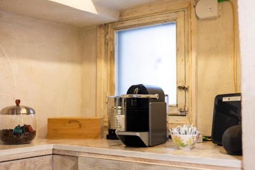 a kitchen counter with a toaster and a coffee maker at Caveau in Palermo