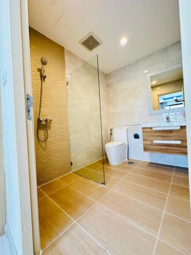 a bathroom with a shower and a toilet at New Ekamai Thonglor Luxury Home near 711, BTS, Mall in Klong Toi