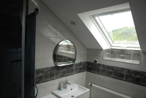 a bathroom with a sink and a window at Pod Żurawiem in Bóbrka